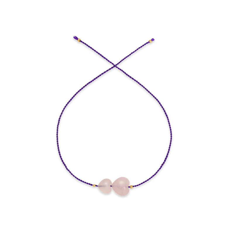  An ankle bracelet on a purple string with hearts 