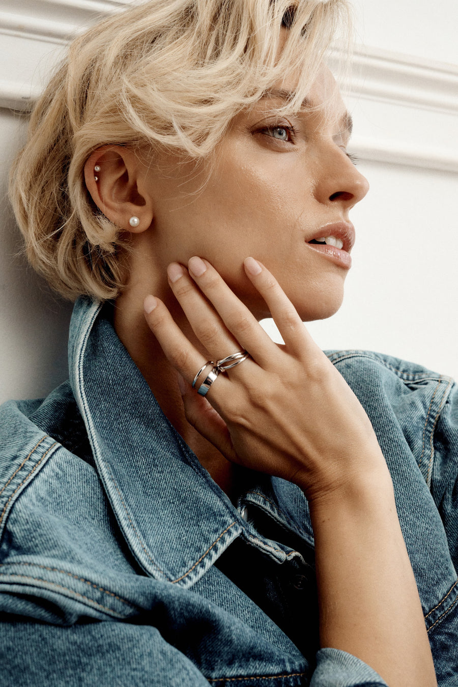 Détail des boucles d’oreilles et des bagues ESSENTIALS avec du denim